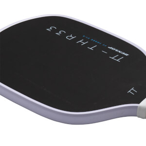 Close-up view of the black paddle face showing "TT - THR33" and "DUNLOP" text with a light purple edge guard.