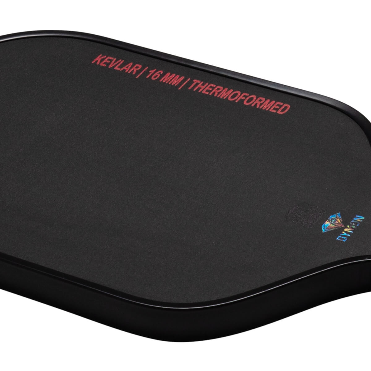 Top-down view of a black pad with red text "KEVLAR | 16 MM | THERMOFORMED" and a diamond logo with "DYMON" text.