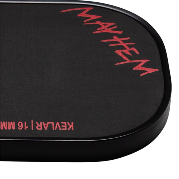 Corner view of a black Dymon Mayhem pickleball paddle with red "MAYHEM" text and "KEVLAR | 16 MM" text.