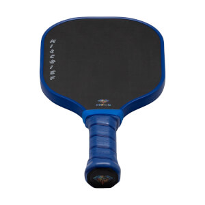Front view of a blue and black pickleball paddle featuring "MISCHIEF" and "DYMON" text on the carbon fiber face and a diamond logo on the handle's base.