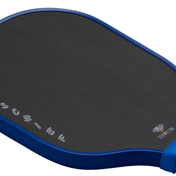Close-up angled view of a blue-rimmed paddle with a black carbon fiber face featuring stylized "MISCHIEF" text and a "DYMON" logo with a diamond.
