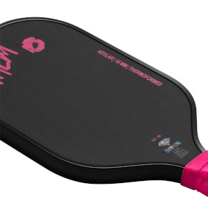 Top-down view of a black pickleball paddle with pink lettering "KEVLAR | 16 MM | THERMOFORMED" and a pink grip.