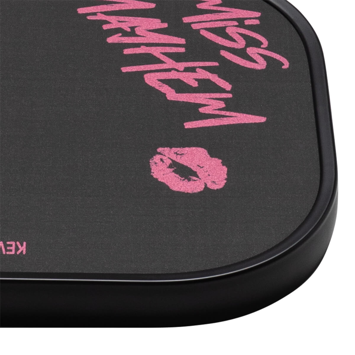 Corner view of a black compact with pink "MISS MAYHEM" text and a pink lipstick kiss graphic.