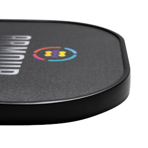 Corner view of a black pickleball paddle with ARMOUR text and a colorful logo.
