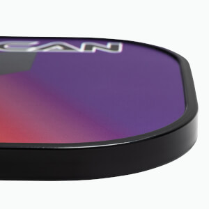 Corner view of a purple and pink pickleball paddle with black trim and visible CAN text.