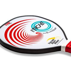 Corner view of a white pickleball paddle with red swirl design, TYCHE logo, and Proudly made in the USA text.