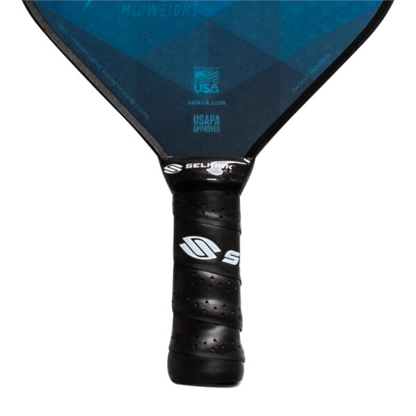 Close-up of a black pickleball paddle grip with Selkirk branding and USAPA approved label.