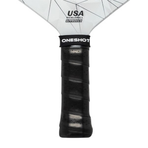 Close-up of a black pickleball paddle grip with ONESHOT branding and USA PICKLEBALL APPROVED on the head.