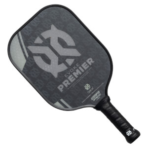 Top-down view of a black pickleball paddle with EVOKE PREMIER text and USAPA approved stamp.