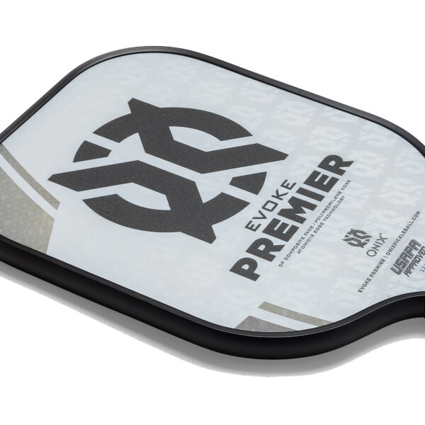 Corner view of a white pickleball paddle with a black logo, EVOKE PREMIER text, and USAPA APPROVED stamp.