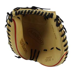 Top-down view of a tan catchers mitt with black lacing, red trim, and Wilson A2000 branding.