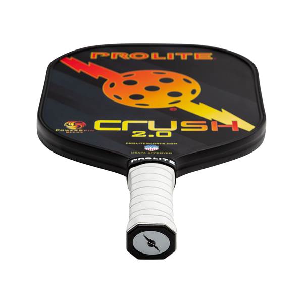 Top-down view of a black PROLITE Crush 2.0 pickleball paddle with a white grip and orange and yellow graphic.