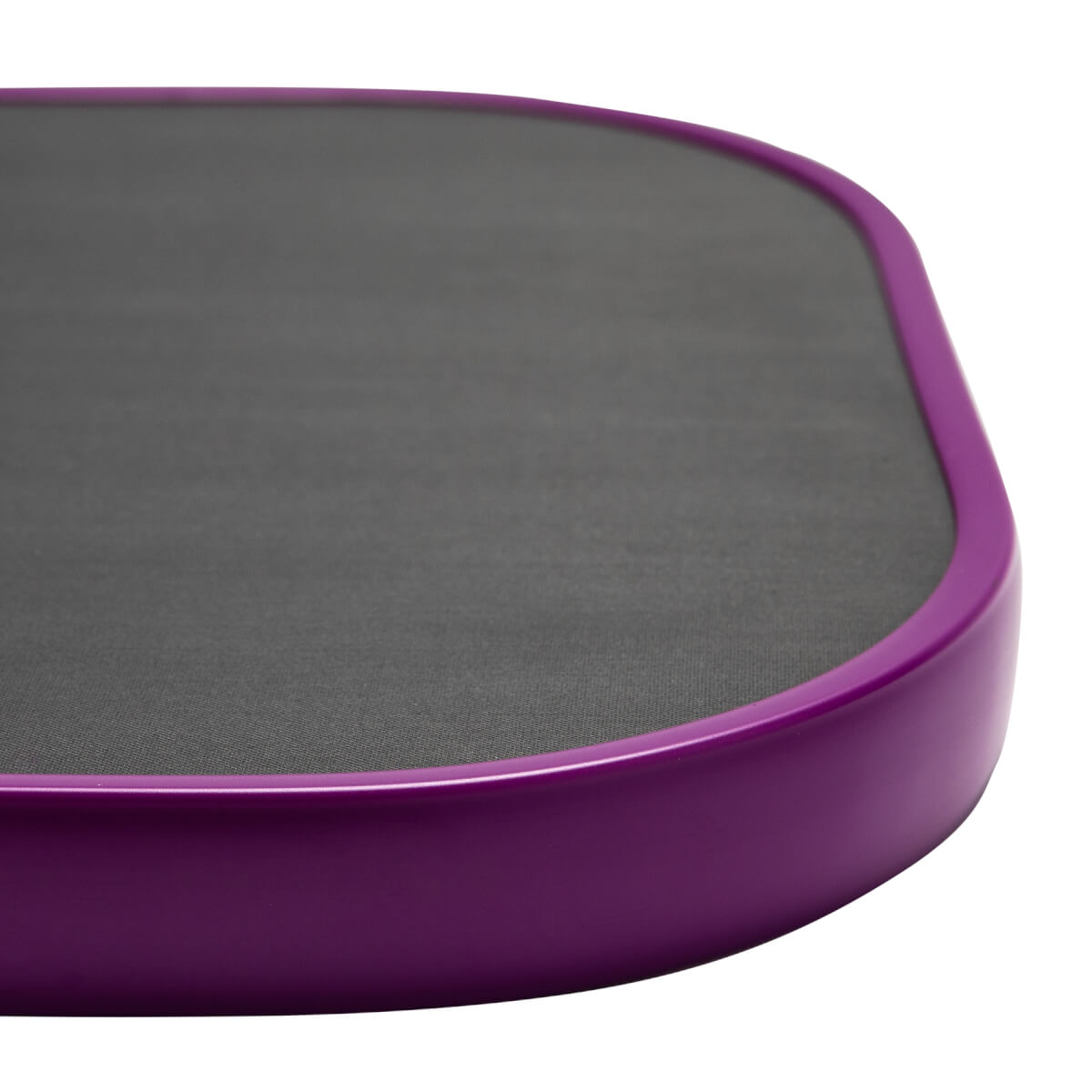 Corner view of a purple pickleball paddle with a dark gray textured surface.