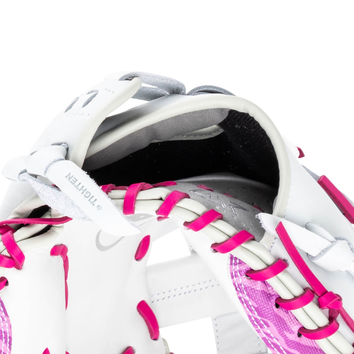 Close-up of a white baseball glove with bright pink lacing and a textured pink pattern.
