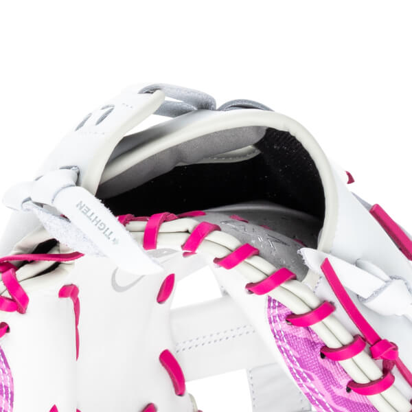 Close-up of a white baseball glove with bright pink lacing and a textured pink pattern.