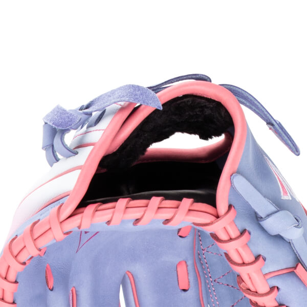 Close-up of a purple and pink baseball glove showing the lacing and interior lining.