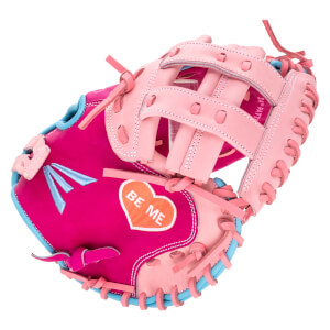 Angled view of a pink and magenta baseball glove with a heart patch that says "BE ME".