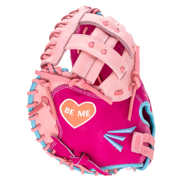Front view of a pink and hot pink baseball glove with a heart graphic that says "BE ME" and blue accents.