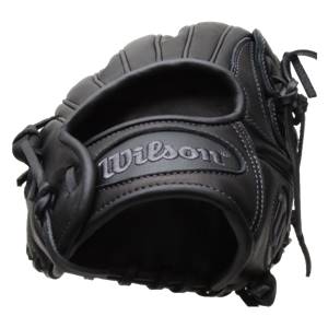 Close-up of a black baseball glove with Wilson embossed on the wrist strap and white stitching.
