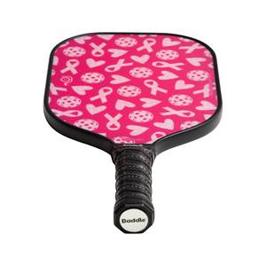 Top-down view of a pink pickleball paddle with white ribbon and heart patterns and a black grip with Baddle branding.