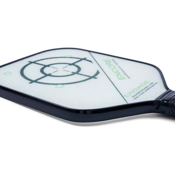 Corner view of a white pickleball paddle with a dark blue edge, green ENCORE text, and a target graphic.
