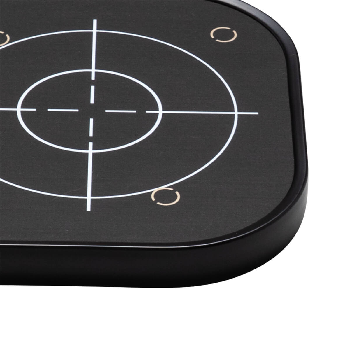 Close-up of a black target with white crosshairs and concentric circles, and two small gold arcs.