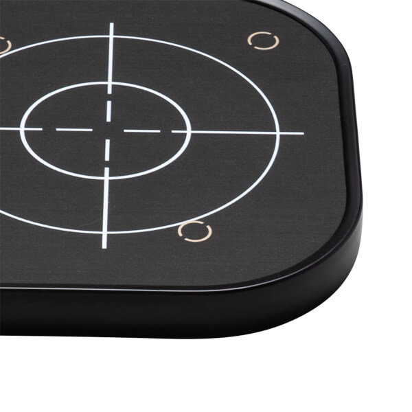 Close-up of a black target with white crosshairs and concentric circles, and two small gold arcs.