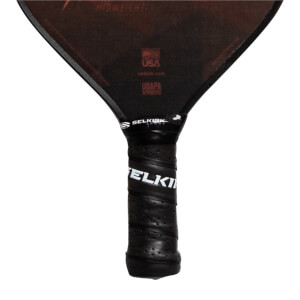 Top-down view of a black pickleball paddle with SELKIRK branding on the grip and MIDWEIGHT text.