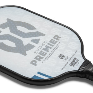 Corner view of a white pickleball paddle with EVOKE PREMIER text and USAPA approved stamp.