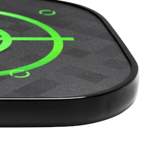 Corner view of a black pickleball paddle with a green target design and textured surface.