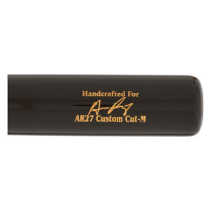 Side view of a black baseball bat with gold text reading Handcrafted For and AR27 Custom Cut-M with a signature.