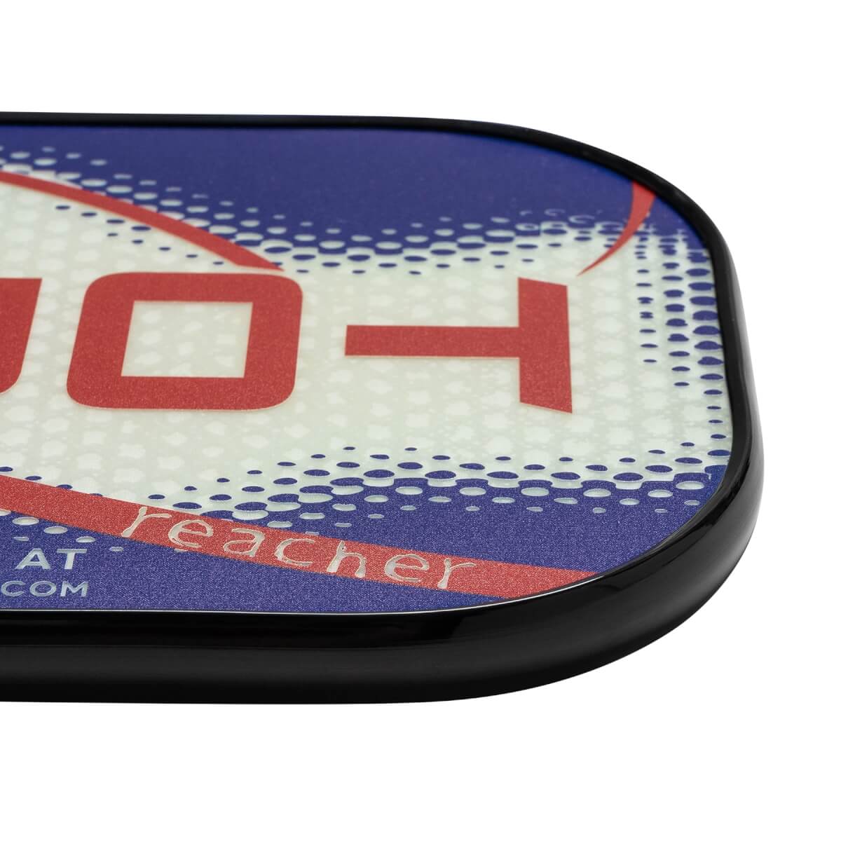 Corner view of a white pickleball paddle with red and blue graphics, showing reacher text.