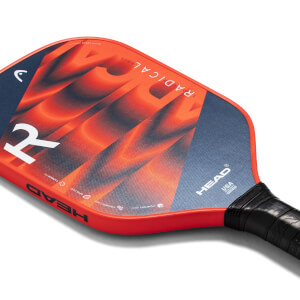 Corner view of a red pickleball paddle with a blue and orange abstract design, HEAD logo, and RADICAL-GRIT text.