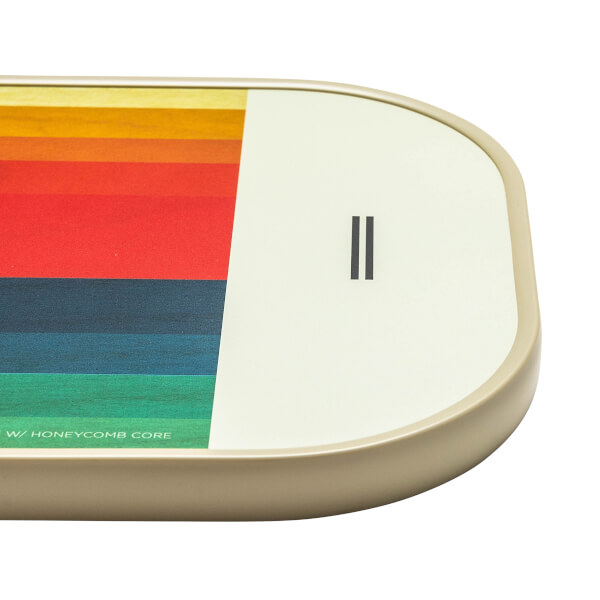 Corner view of a cream pickleball paddle with a rainbow stripe design and black double bar logo.