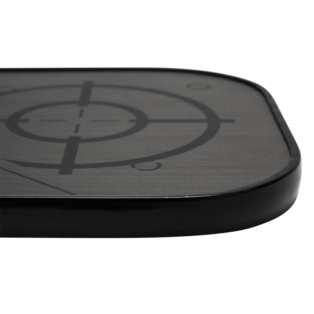 Corner view of a black pickleball paddle with a target graphic and textured surface.