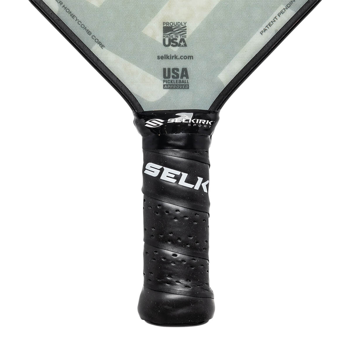 Close-up of a black pickleball paddle grip with SELKIRK SPORT and SELK branding, and USA PICKLEBALL APPROVED text.