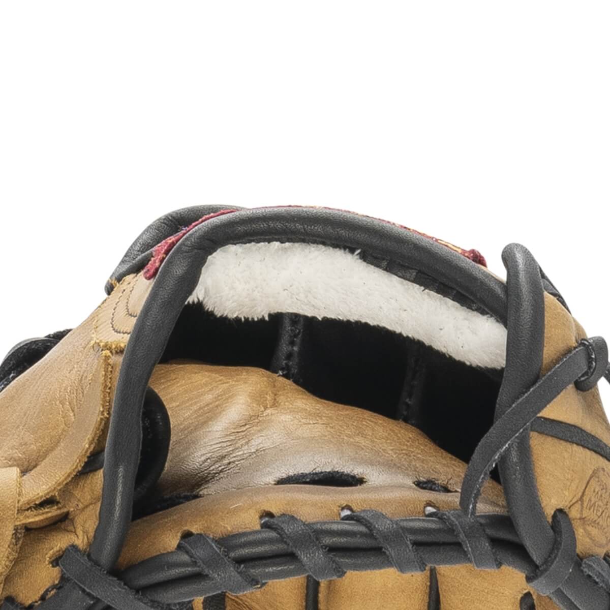 Close-up of a tan baseball glove with fluffy white wrist padding, black lacing, and reddish-brown trim.