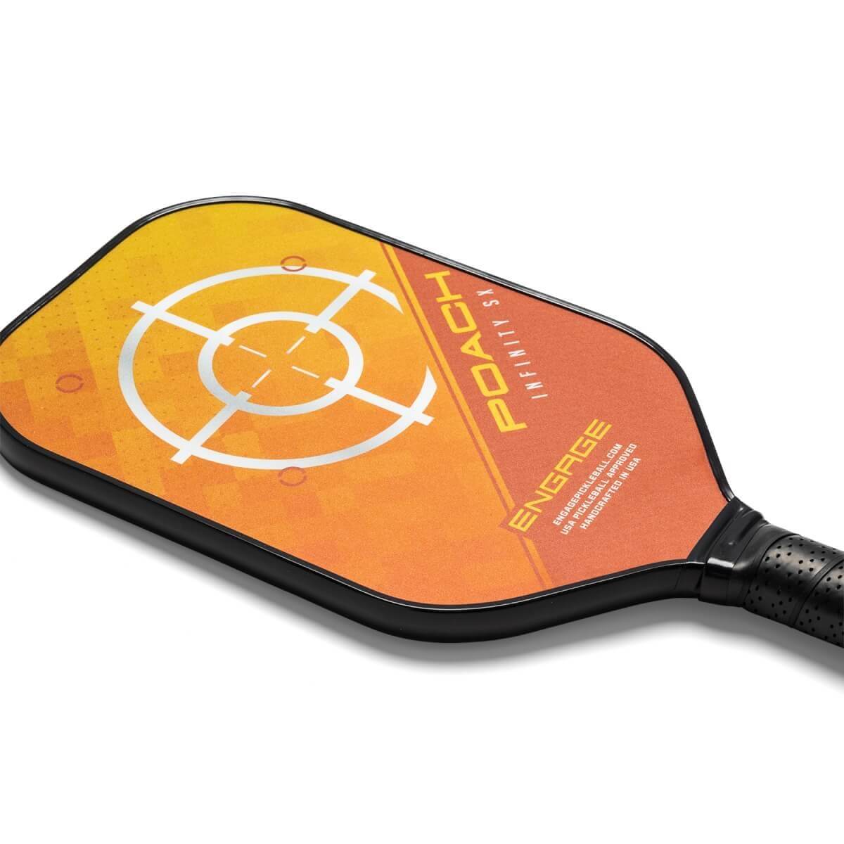 Corner view of an orange pickleball paddle with a target design, POACH INFINITY SX text, and ENGAGE branding.
