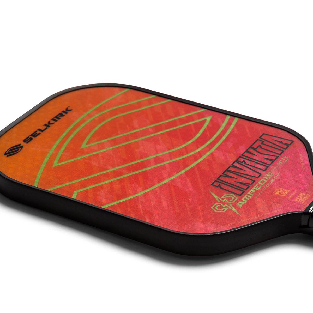 Corner view of a red and orange pickleball paddle with green lines and INV IKTA AMPED text.