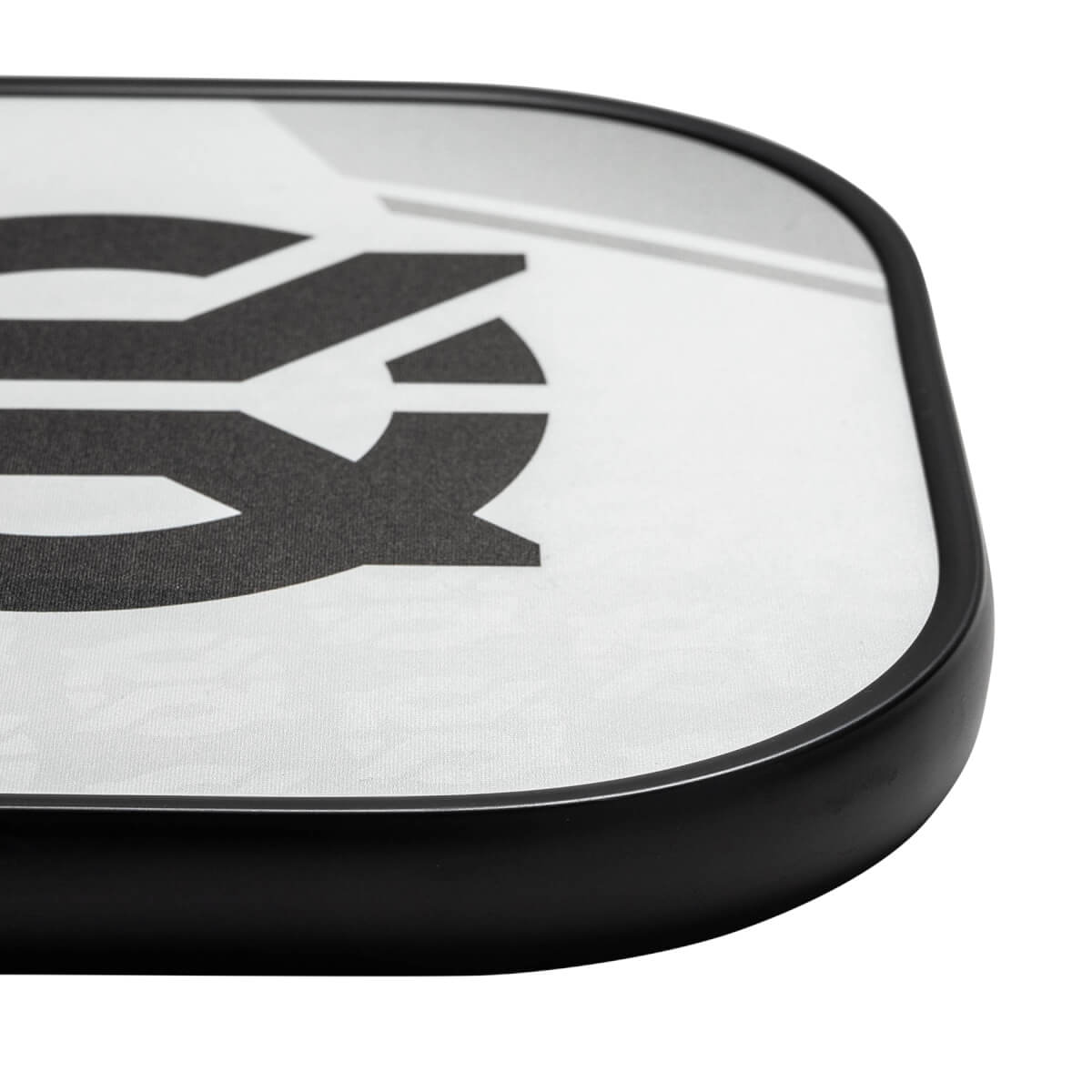 Corner view of a white pickleball paddle with a black border and a large black graphic.