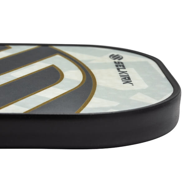 Side view of a white pickleball paddle with black and gold accents and the Selkirk logo.