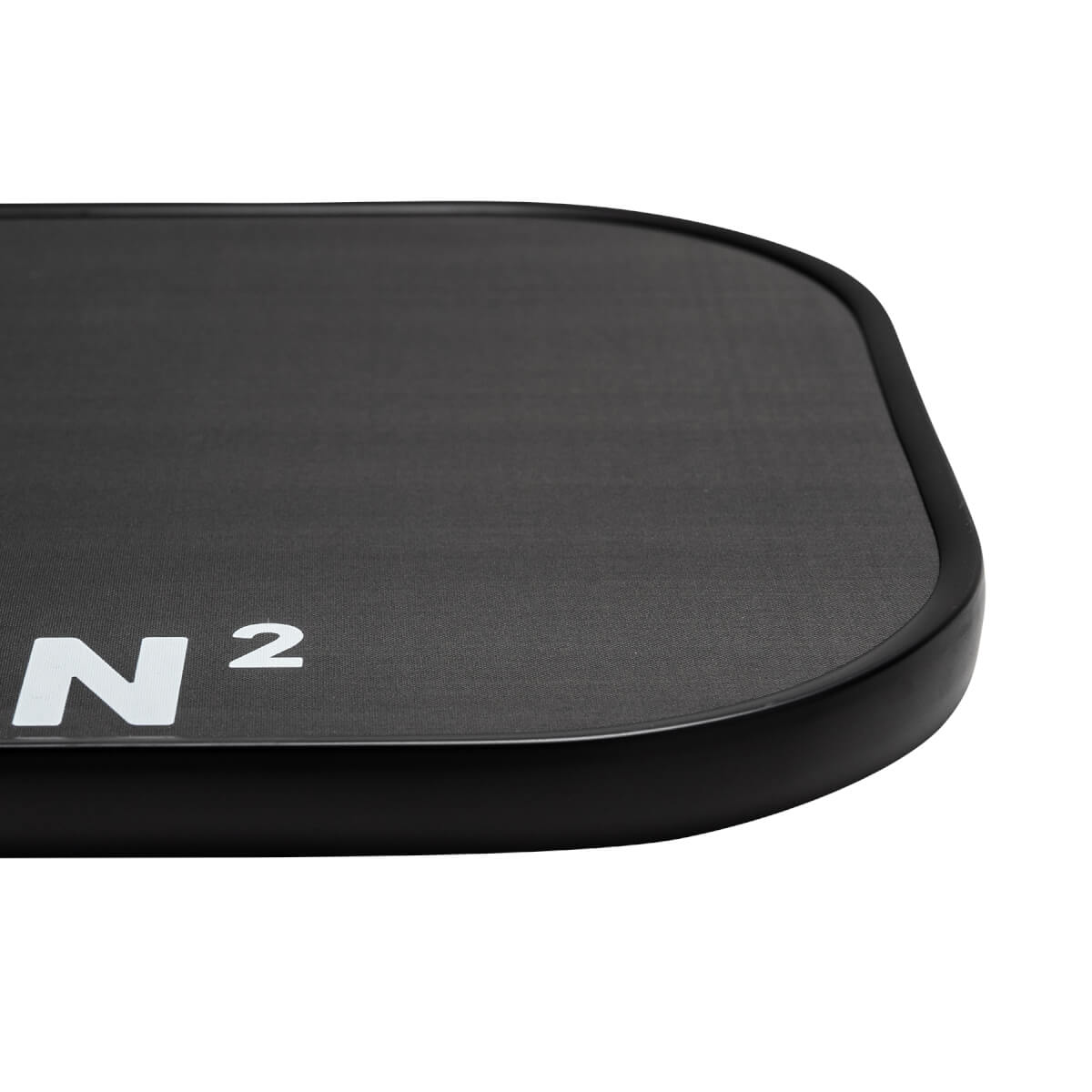 Corner view of a black pickleball paddle with white N 2 branding and a textured surface.