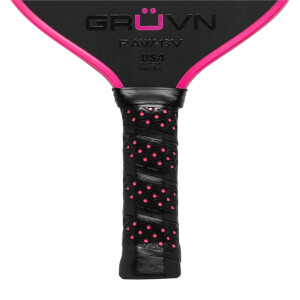 Close-up of a black GRUVN RAW-13V pickleball paddle with pink trim and a textured grip.