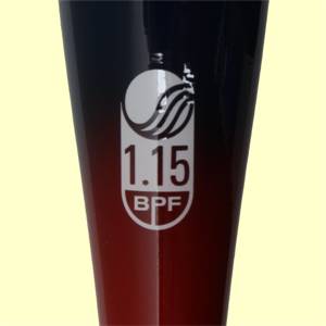 Close-up of a dark blue and red youth baseball bat with a white oval logo displaying 1.15 BPF.