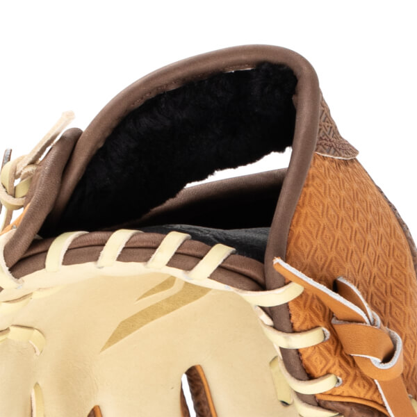 Close-up of a baseball glove showing tan leather, brown trim, and a textured pattern.