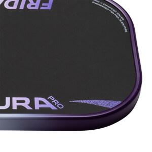 Close-up of a black pickleball paddles bottom right corner with a purple edge guard, AURA PRO text, and speckled design.