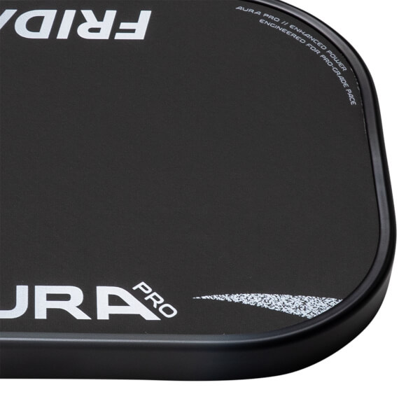 Close-up of a black pickleball paddle with FRIDAY and AURA PRO text, and curved enhanced power detail.