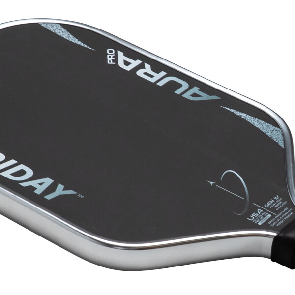 Close-up of a pickleball paddle showing the "PRO AURA" logo and "USA" text.