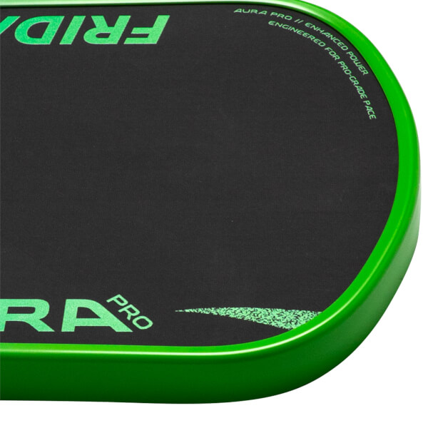 Corner view of the 'FRIDA' pickleball paddle showing the green edge and the words 'AURA PRO' and 'PRO-GRADE PACE'.