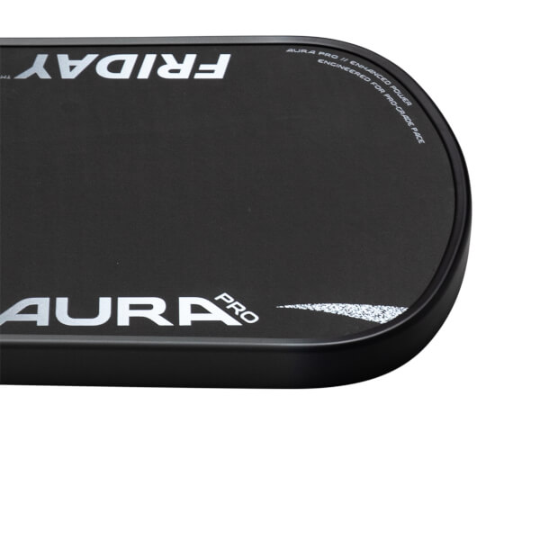 Corner view of a black 'FRIDAY' pickleball paddle with 'AURA PRO' and 'ENGINEERED FOR PRO-GRADE FACE' text.